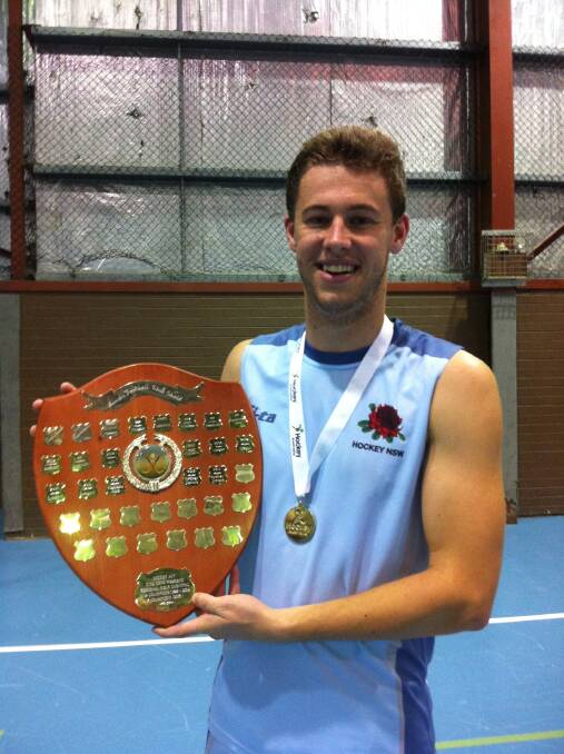 PROUD MOMENT: Alex Mackay shows off the championship shield.  