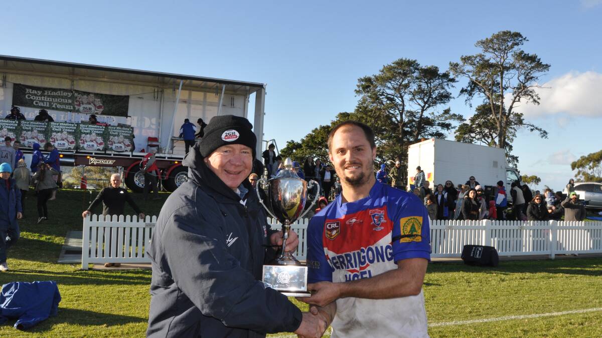 PROUD MOMENT: Immortal Bob Fulton presents the Continuous Call Team Cup to Gerringong captain Brad Davidson after his side's 34-6 win over Kiama.  