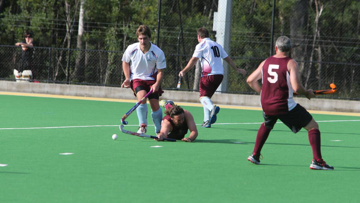 OUCH: Kangaroo Valley’s Chris Hindman hits the deck as he tries to steal possession from Shoalhaven Heads’ Lachlan Butfield. Photo: ROB CRAWFORD 
