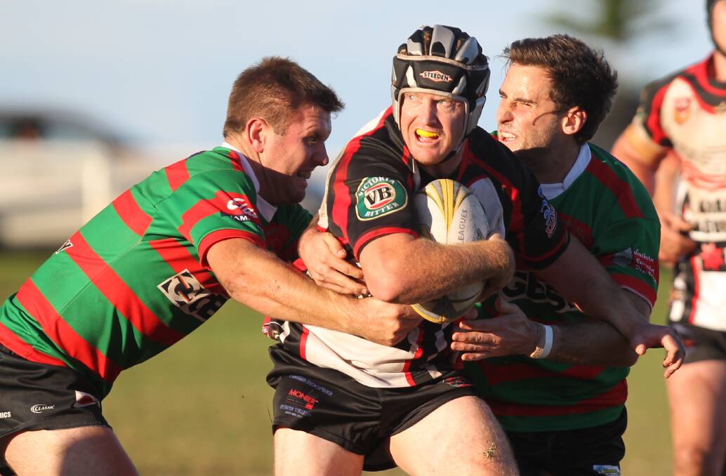 THRILLER: Kiama Knights co captain Marc Laird tries to break away from the Jamberoo defenders during their 30-28 win at Kiama Showground on Saturday. Photo: DAVID HALL  