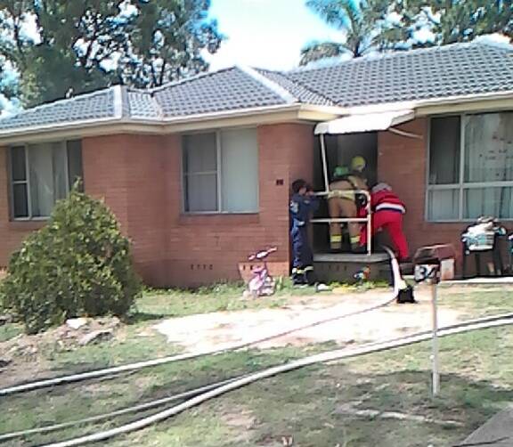 Firies entering the house. Picture: Michael Johnson