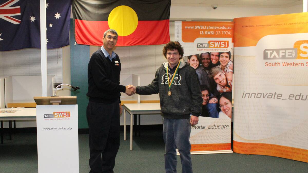 TAFE teacher Richard Jordan and student Justin Fenton from Shoalhaven Auto Electrical after Justin won gold at a WorldSkills competition.