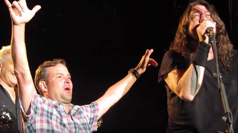 Foo Fighters' front man Dave Grohil with his emotional fan, Anthony, on stage.