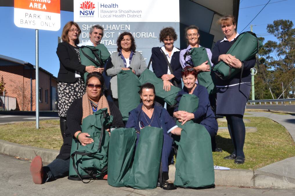 HOMELESS HELP: St Vincent de Paul Society John Purcell House case worker Stacey Ellard (front left) accepts the Street Swags from Shoalhaven Hospital staff members (back from left) Shayne Fletcher, Dominique Stephanidis, Violet Green, Wendy Fetchet, Bec Houghton, Bec Underdown, Jo Carrick (middle) and fundraising organiser Karen Raymond (front).
