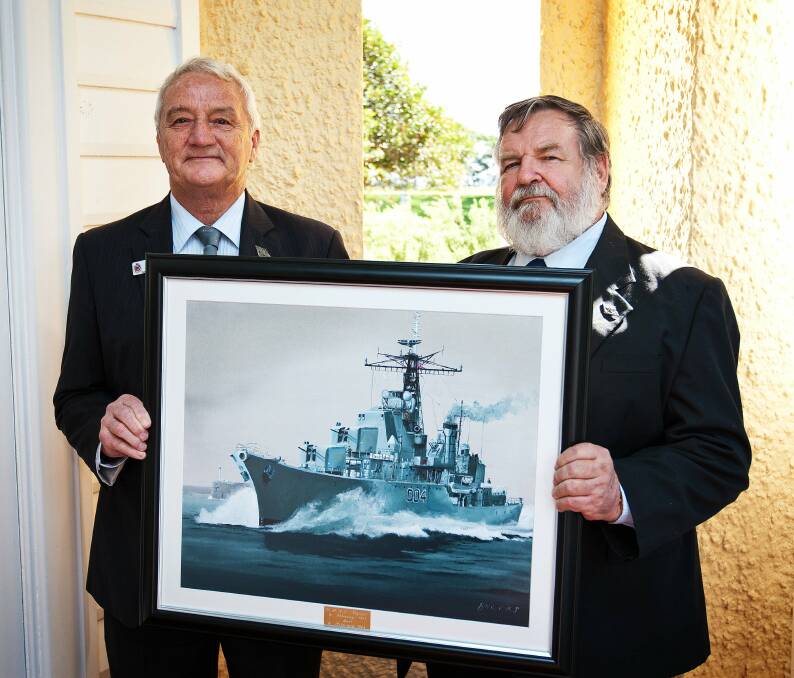 GIFT: Bob Auston and Barry Brooks with a painting of HMAS Voyager donated to the RAN Historical Collection at HMAS Creswell. Photo: JESSE RHYNARD 