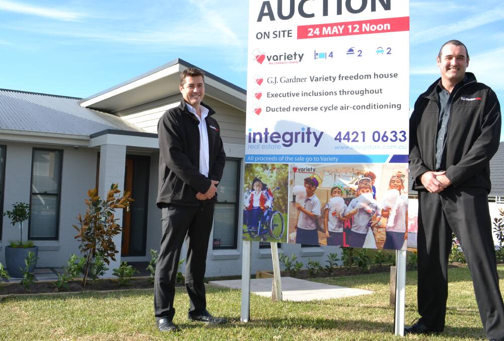 FOR SALE: GJ Gardner Homes Shoalhaven directors Sean Vickery and Nathan Fay stand proud in front of what has become a major community achievement. Photo: MAISIE COHEN