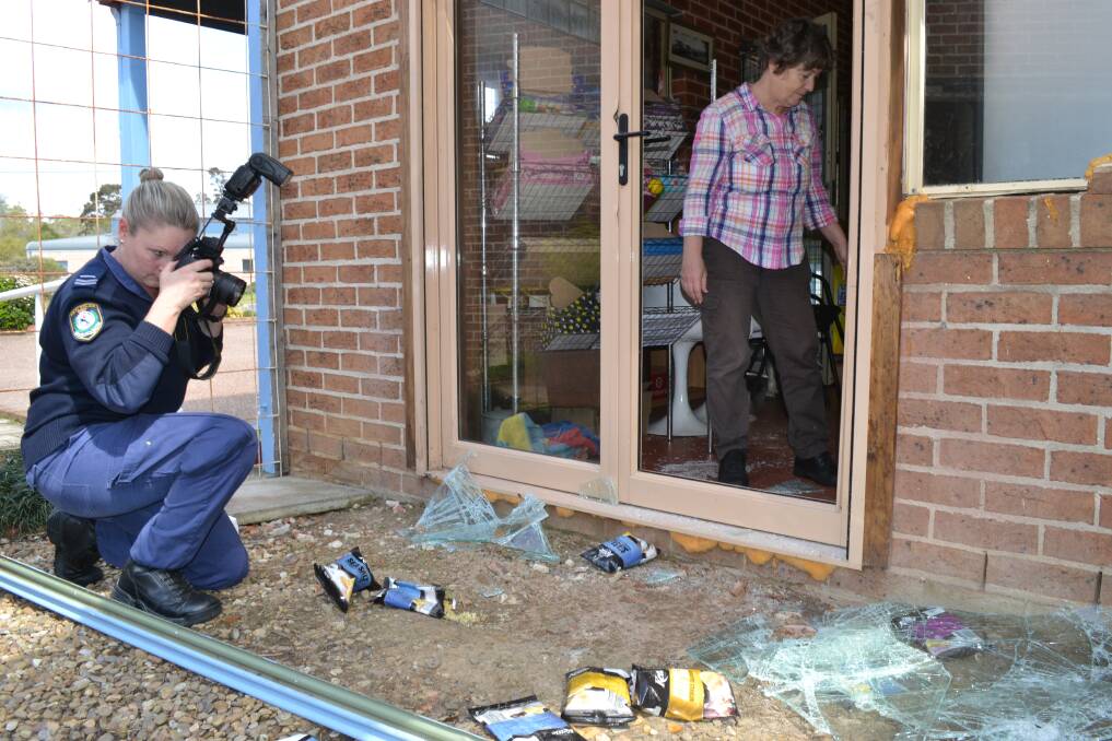 RAMPAGE: Bluedog Country Cafe owner Maralyn Moseley surveys the damage from Tuesday morning’s break-in as Senior Constable Pep Reid photographs the area.