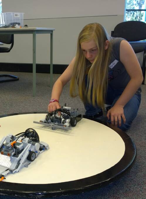 ROBOAPOCALYPSE: Bomaderry resident Angelina Cusack tests her robot creation at the last Lego Mindstorms workshop held at the Shoalhaven Campus of the University of Wollongong.