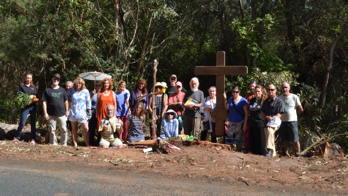 BUMMER: More than 20 people gathered around the site of the once majestic Bum Tree on Tuesday to unveil a wooden cross dedicated to not only its removal but more than 140 trees along Gerroa Road.