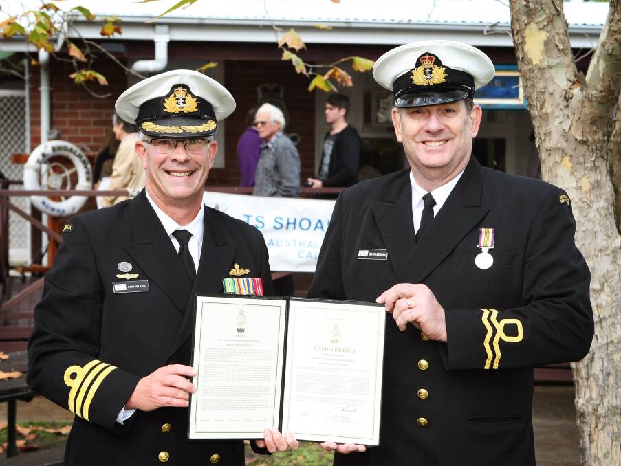 AWARD: HMAS Albatross executive officer Commander Gary Holgate presents commanding officer of Training Ship Shoalhaven, Lieutenant John Huisman with his commendation.