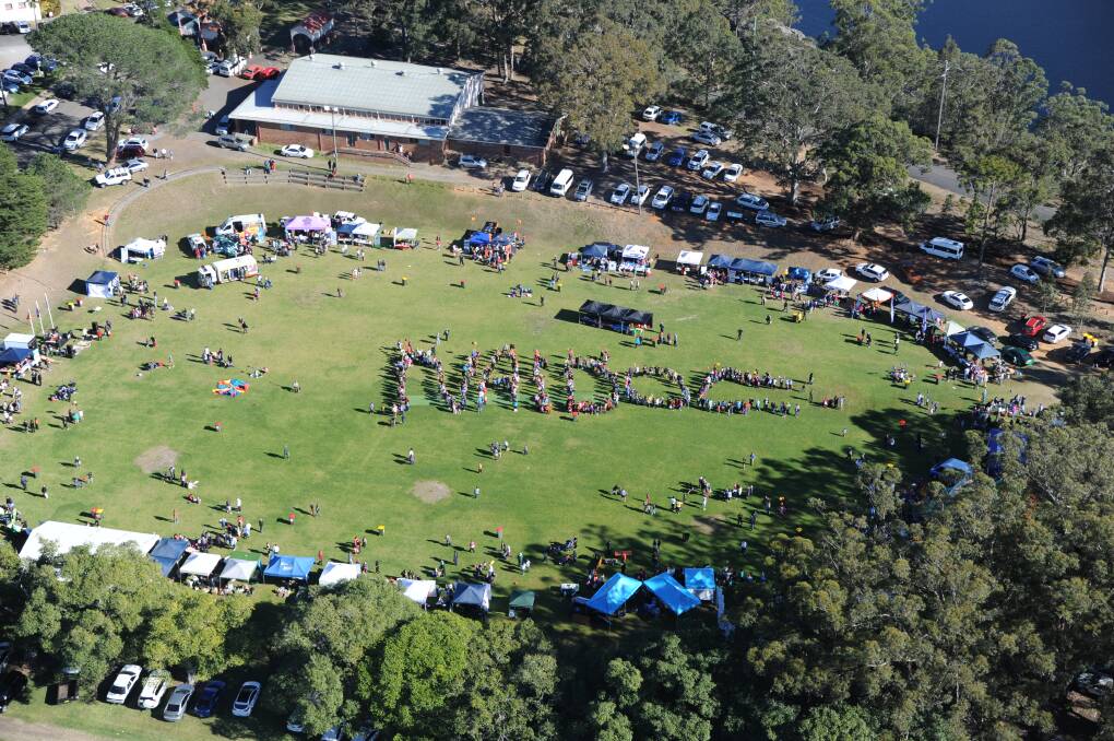 UNITY: The crowd at the NAIDOC Week Family Fun Day in Nowra formed a human sign on Wednesday.