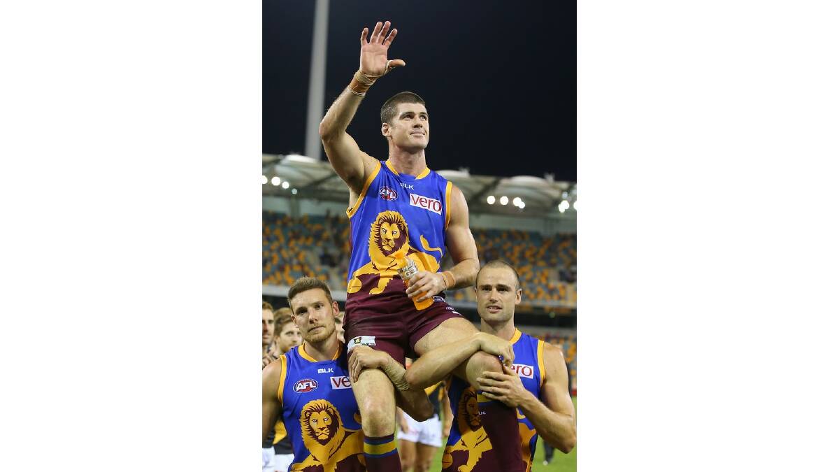 Jonathan Brown of the Lions is chaired from the field after playing his 250th game during the round five AFL match between the Brisbane Lions and the Richmond Tigers at The Gabba on April 17, 2014 in Brisbane, Australia. Photo: Chris Hyde/Getty Images.