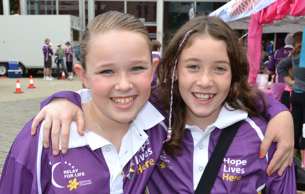 FRIENDS: Amy Whelan and Emma Falls from Cambewarra walk their Relay For Life laps together at the Shoalhaven Entertainment Centre on Saturday.