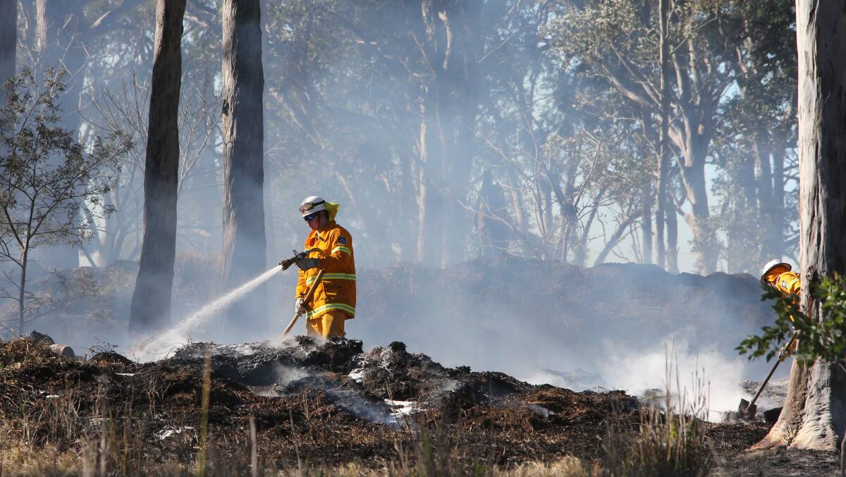 MOPPING UP: RFS firefighters work at blacking out a fire in Worrigee.
