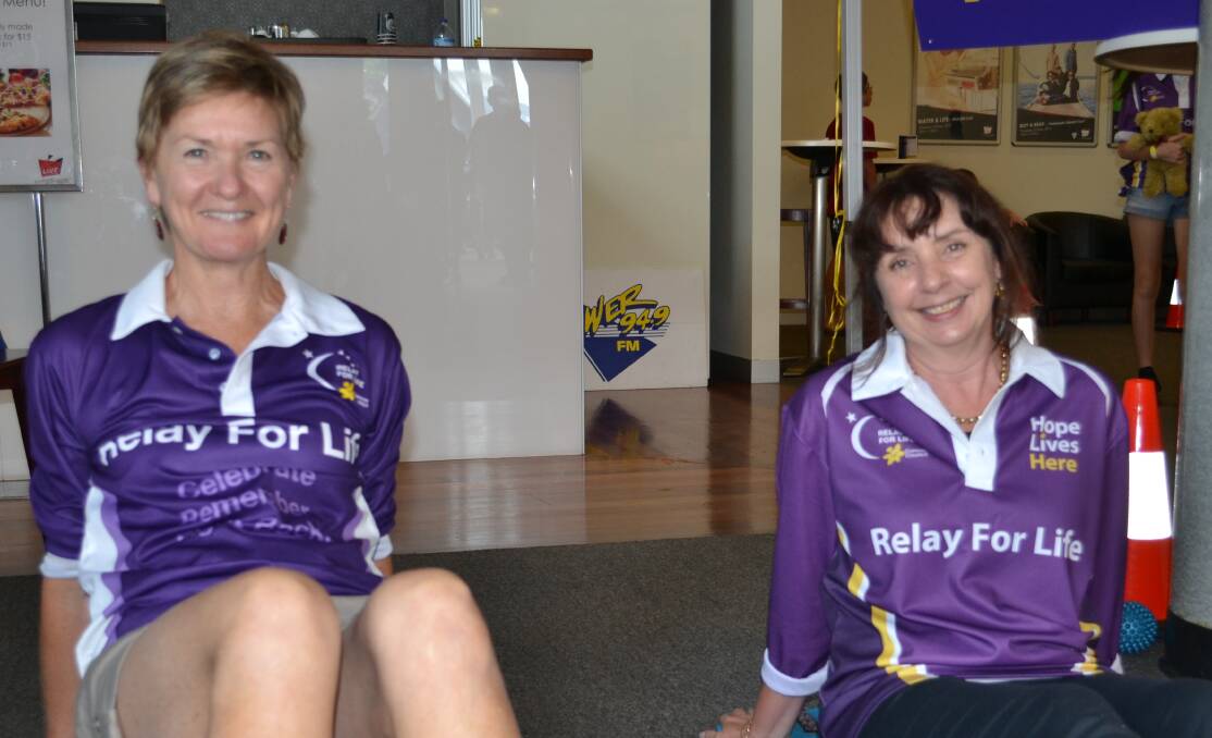 STRETCH: Kathy Johnson from North Nowra and Jane Brennan from Nowra show everyone from Relay For Life how to stretch and look after themselves at the Shoalhaven Entertainment Centre on Saturday.