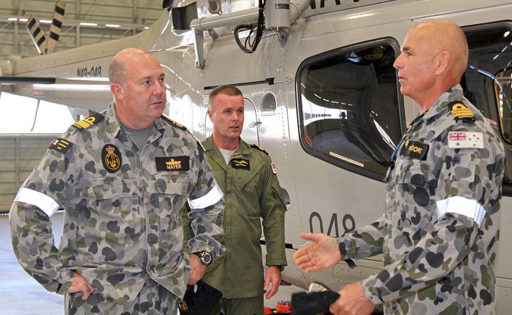 Commander Australian Fleet, Rear Admiral Stuart Mayer speaks with Commander Alan Moore during a tour of 723 Squadron at HMAS Albatross.