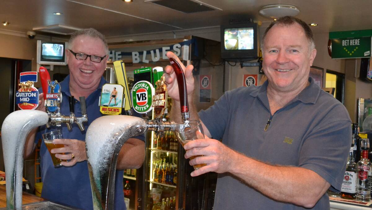 POURING ON: New owners of the Bomaderry Hotel, Lloyd Segerstrom (left) and former Australian rugby league representative Ian Schubert get down to work pulling beers.