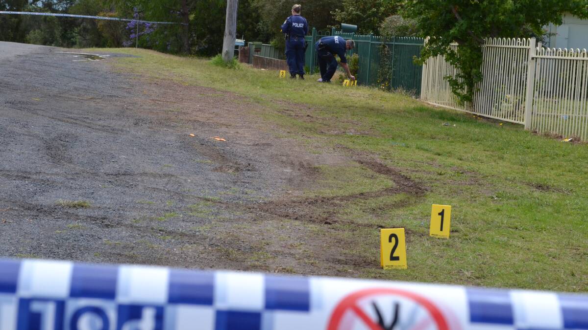 Nowra Crime Scene officers Senior Constable McInnes and Senior Constable Reid lay out evidence markers at the scene of the incident in East Nowra last November.