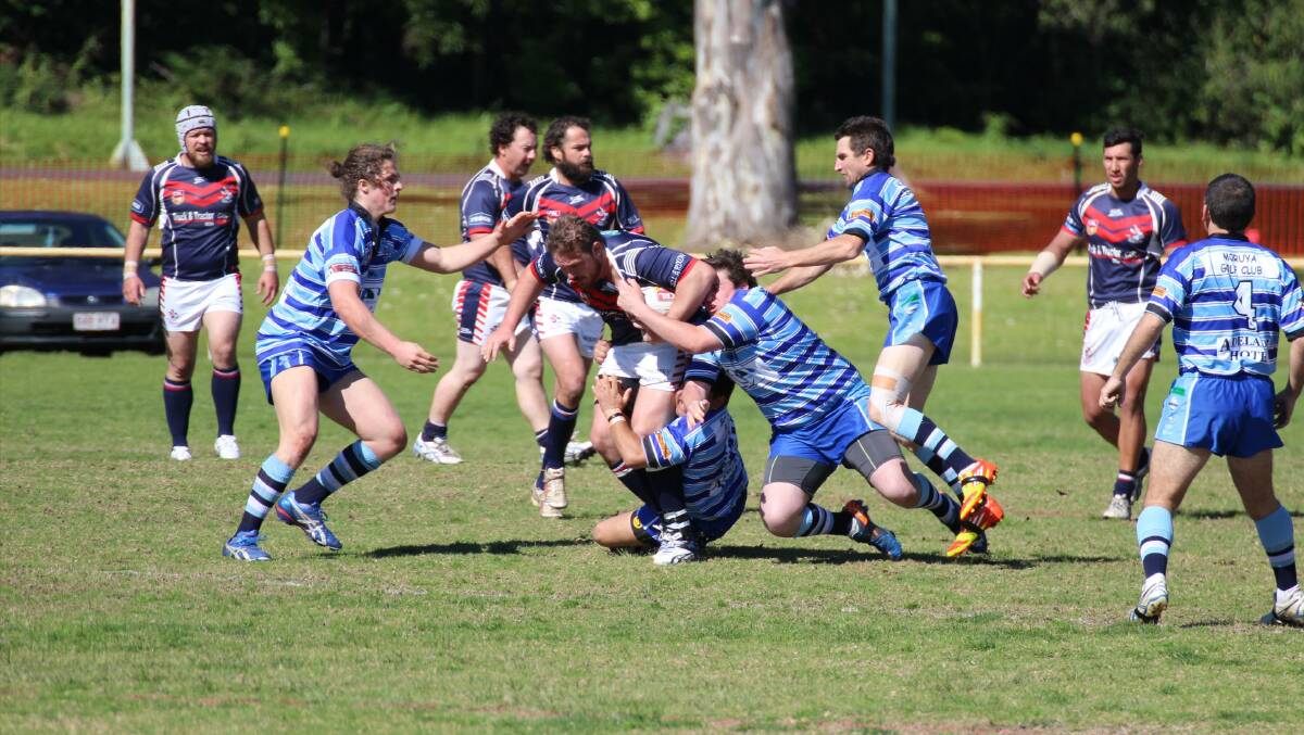 HOLDING ON: Four Moruya Sharks reserves players surround a Bega Rooster on Sunday.  