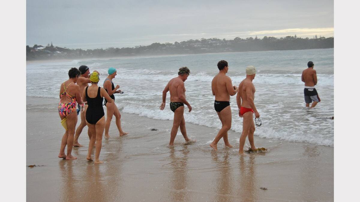 ULLADULLA: A group takes to the water at Mollymook Beach yesterday for the regular early morning swim from near the golf club to the reef and back, undeterred by the fatal shark attack at Tathra the previous week.