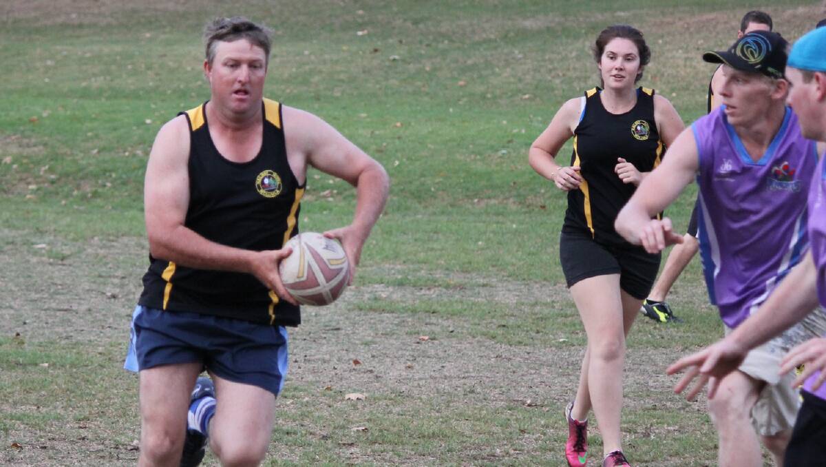 BEGA: Wolumla Hotel player Stuart McPaul looks for an offload with Caitlin Johnson in support during the Bega touch football grand final on Friday. 