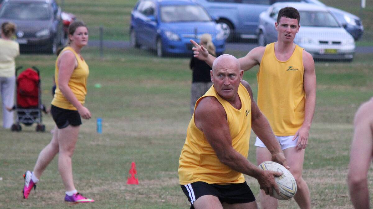 BEGA: Ray Ryan (with ball) goes for a pass during the Bega touch football B grade grand final. 