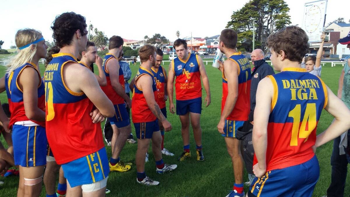 BERMAGUI: Narooma AFL Lions 2014 Captain, Lawrie Hodgson (centre) addresses his troops at halftime on Saturday in the game against Bermagui at Bermagui.