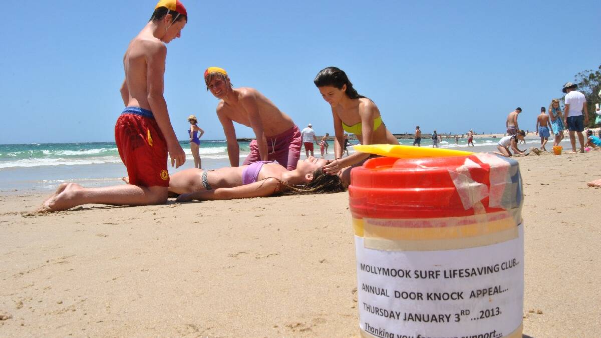 ULLADULLA: Young Mollymook Surf Life Saving Club 

members Michael Walsh and Tom Woodward practice 

their lifesaving skills on Siena Montgomery of 

Canberra, while her cousin Indianna Davies of Cairns 

lends a hand. 