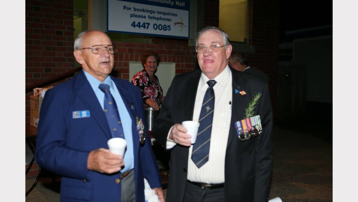 Greg Wise and Barry Brown catch up at the Anzac Day dawn service at Greenwell Point.