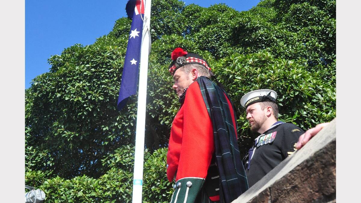Shoalhaven Pipes Band member Chris Langmaid with Petty Officer Jason Smith.
