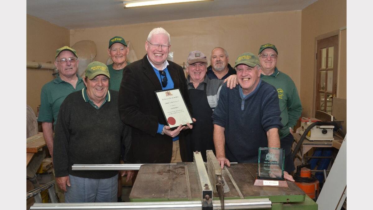 Member for Kiama Gareth Ward presented Ken Merrifield from Shoalhaven Heads with the Premier’s Community Service Award on Monday. He is pictured with members of the Shoalhaven Heads Men’s Shed.