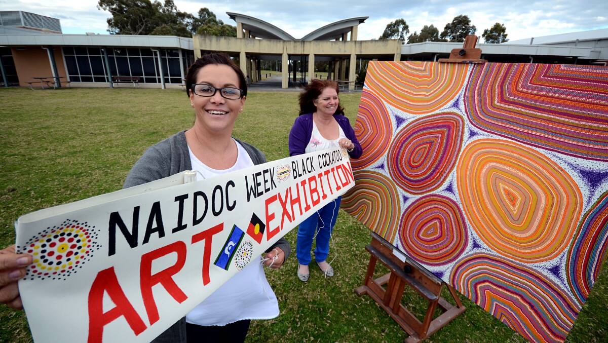 EYE CATCHING: Leah Nixon and Diane Pirotta invite the community to see some of the region’s finest Aboriginal art during this year’s Annual Black Cockatoo Aboriginal Art Award. The exhibition is at the University of Wollongong, Shoalhaven campus, West Nowra. Photo ADAM WRIGHT. 