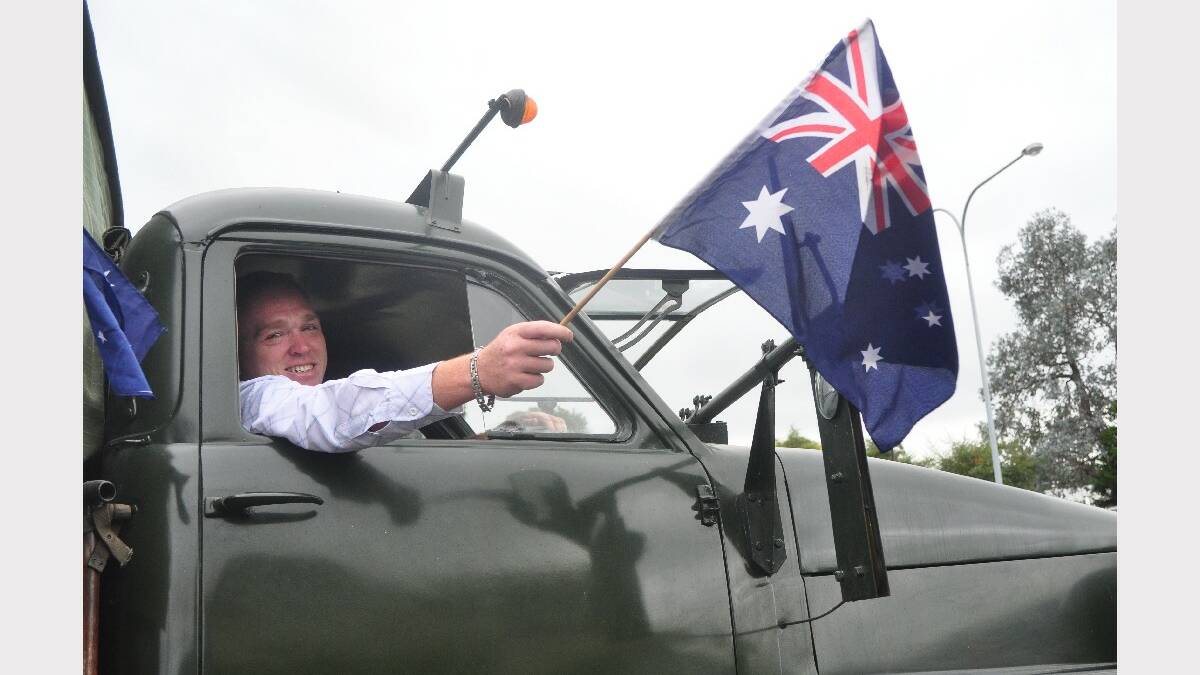 Jason Mayers proudly waves the Australian flag.