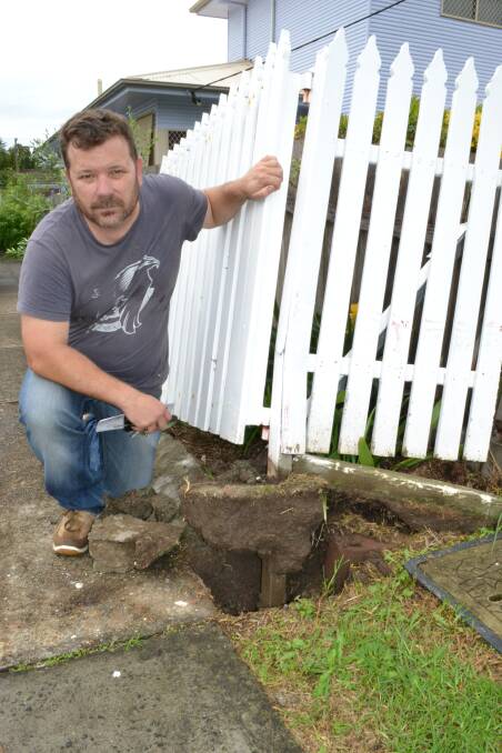 DAMAGE: Ernest Street resident Dean Morgan pleads with council to have speed humps put in after a car lost control, destroying his fence on Friday afternoon.