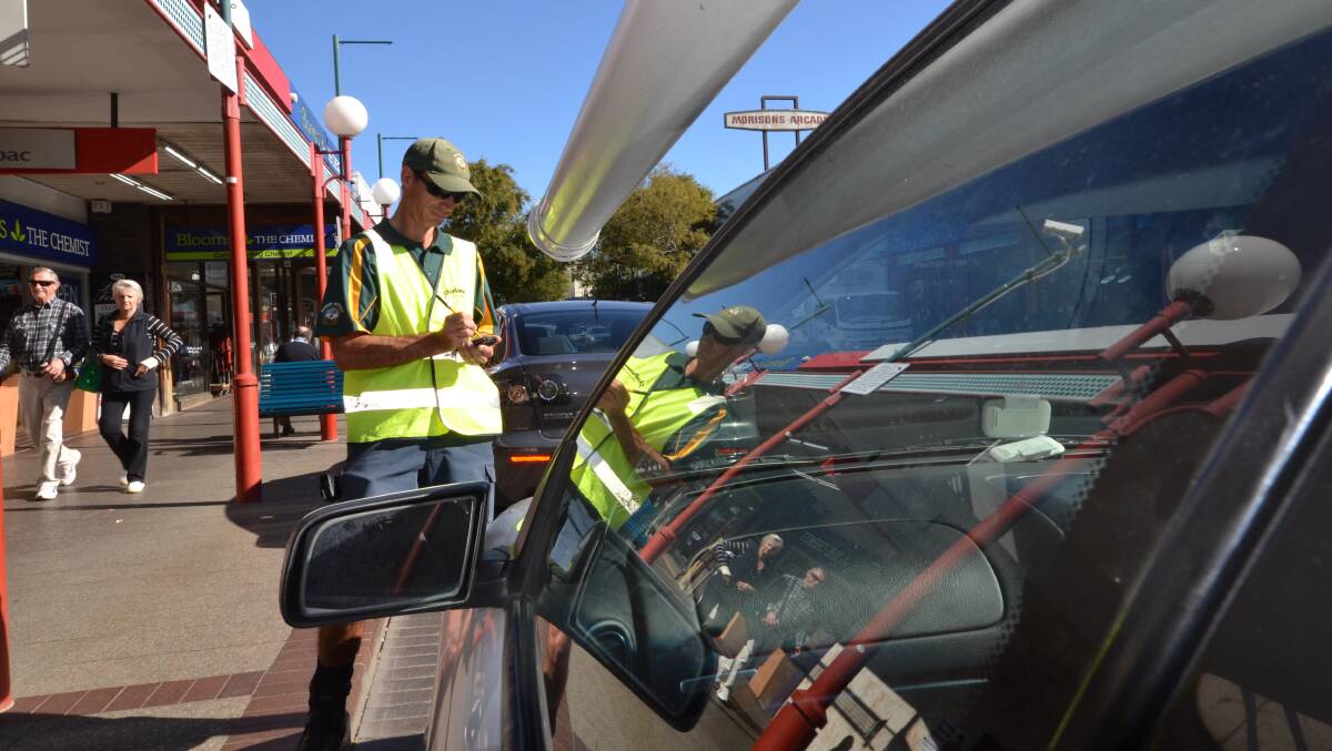 TICKET: A Shoalhaven City Council parking ranger does the rounds of the Nowra CBD.