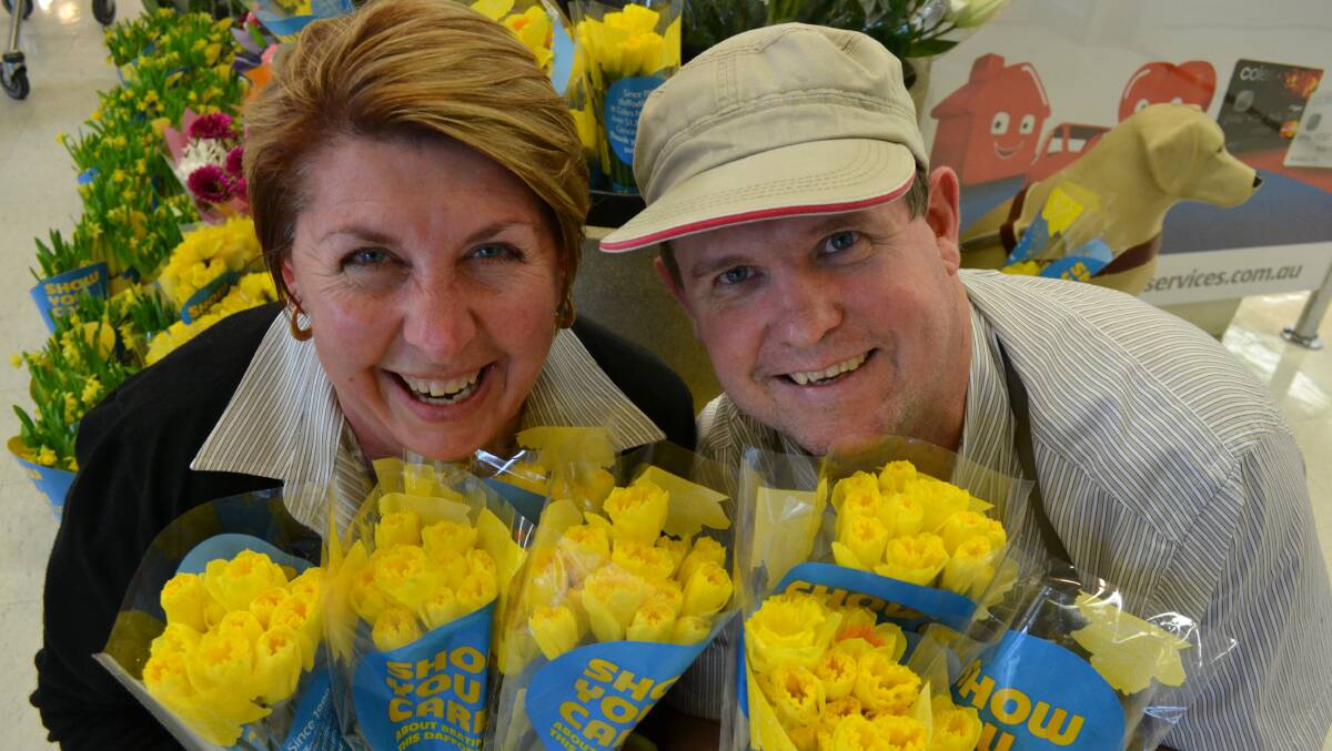 MELLOW YELLOW: Coles checkout second-in-charge Kerrie-Anne Barnes and fresh produce worker Adrian Armstrong are happy to support Daffodil Day. 