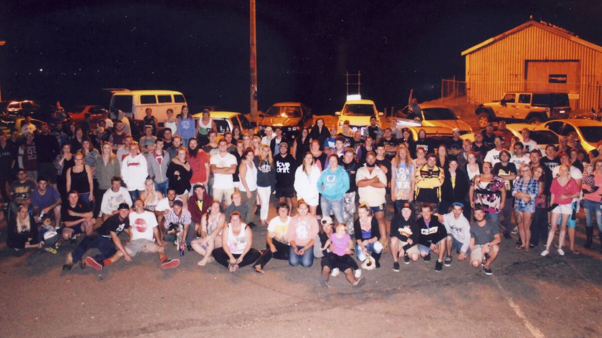 UNITED: A group photo taken on Tuesday night of hundreds of local car enthusiasts who took part in a tribute drive in memory of their friend.