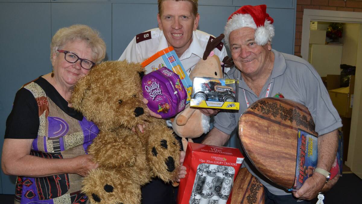 MERRY MISSION: Maz Bevan-Williams, Salvation Army Lieutenant Dominic Wallis and Peter Williams with some of the toys and food donated to help those in need across the Shoalhaven. 