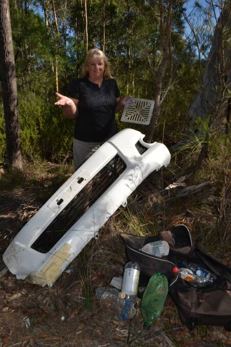 JUST RUBBISH: North Nowra’s Crams Road resident Shirley Roth can’t understand why people would spoil the beautiful bushland near her home to illegally dump general rubbish and household goods.