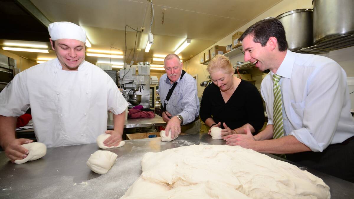 MOULDING THE FUTURE: Award-winning fourth-year baking apprentice Alex Ivanoff, baker John Reminis, with Member for Gilmore Ann Sudmalis and Assistant minister for Education and Training, Senator Simon Birmingham on Friday. Photo: ADAM WRIGHT