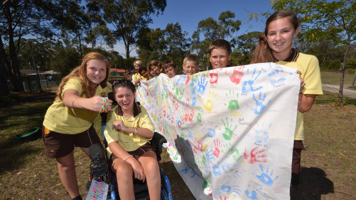 MAKE A STAND: Shoalhaven High School year 7 students Chloe Turner and Jordan Taunton surrounded by their friends Mikayla Reeves, Reece Christian, Jayden Wright, Jordan Francis, Cynthia Rebic, Olivia Woodlands, Dre James-Howlett, Guy Calderon and Jesse Biddle who place hands on a mural to show they will not accept bullying.