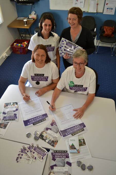 PLEDGE: Shoalhaven Neighbourhood Services administrator Maxine Edwards and Shoalhaven Women’s Health Centre manager Tracy Lumb watch over South Coast Labor candidate Fiona Phillips and South Coast Greens candidate Amanda Findley as they sign a pledge to continue to support and strengthen funding into the community resources.