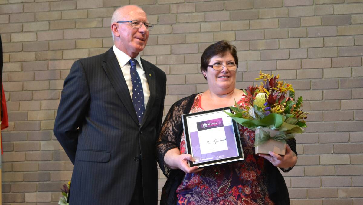 RECOGNITION: His Excellency General The Honourable David Hurley AC DSC presents Nowra Unit SES volunteer and 2014 South Coast Woman of the Year Jo Allen with her award at the Wesley Centre in Nowra.