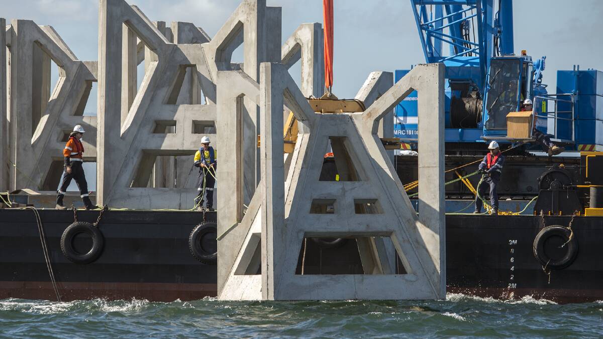 BIG DROP: A 23-tonne concrete structure that forms part of an artificial is lowered into the sea off Shoalhaven Heads.