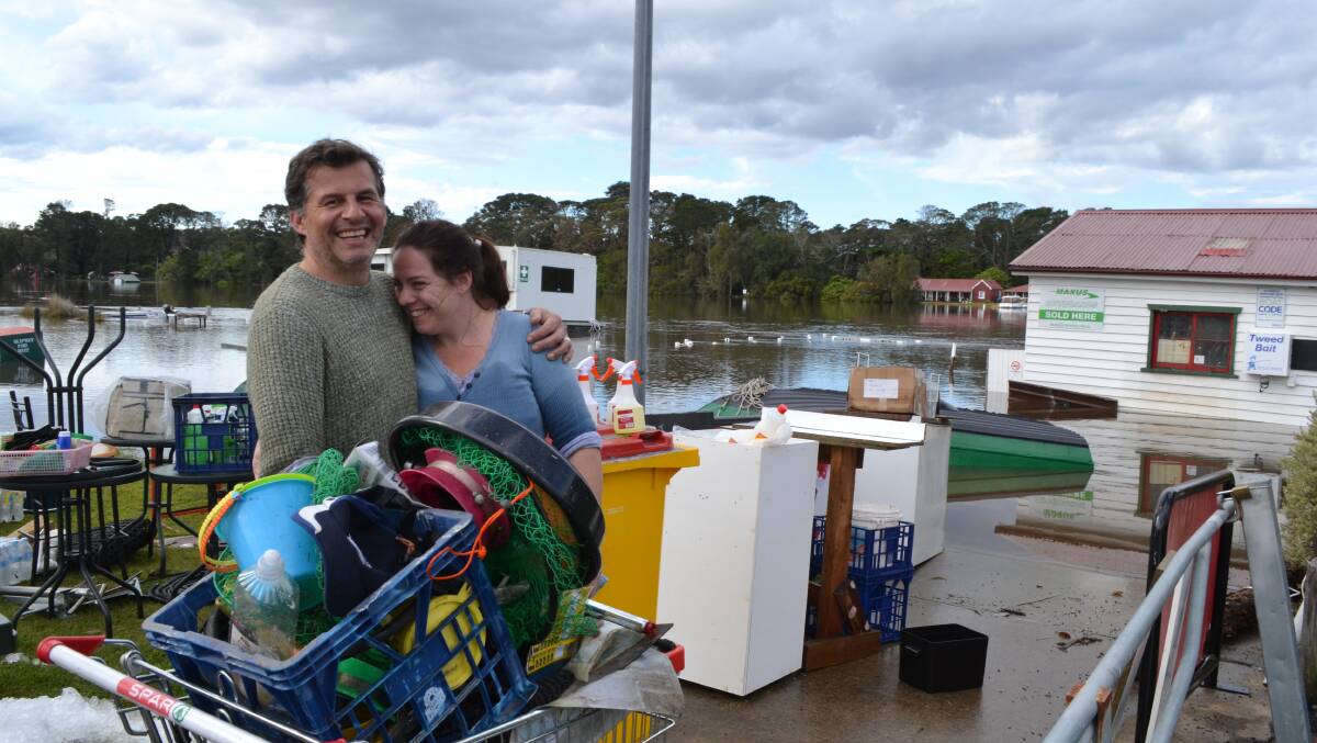 CHEERFUL: Despite their business being inundated by floodwaters Sussex Inlet couple Brian and Samantha Betts could still smile.