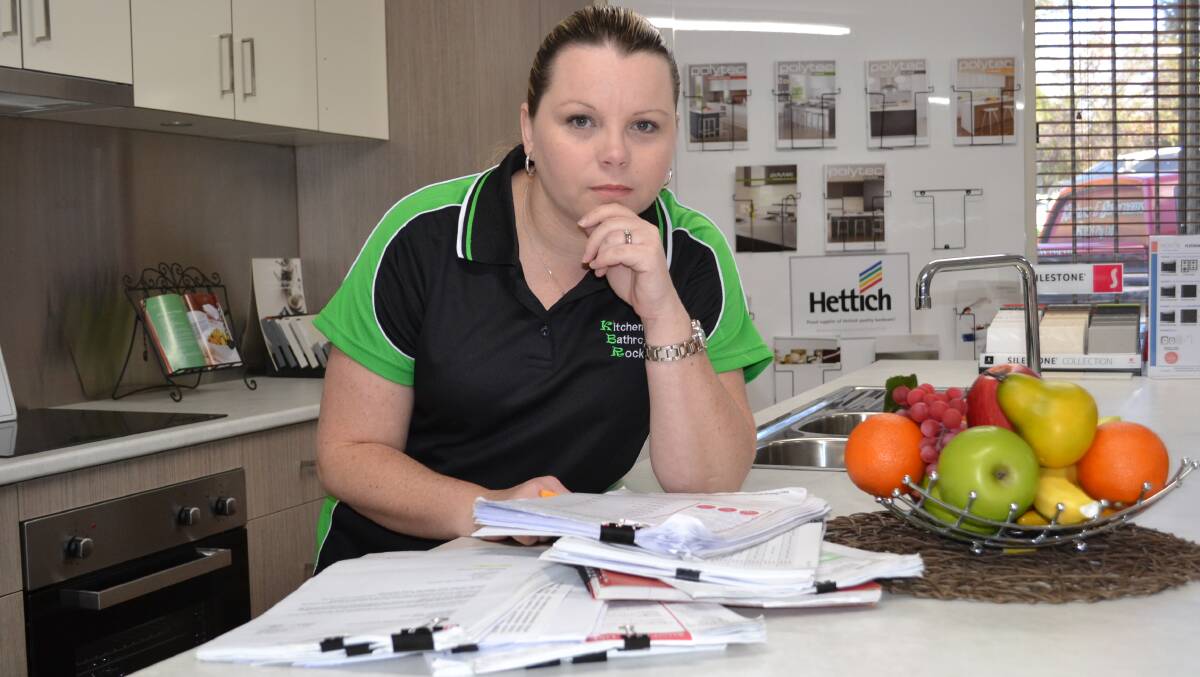 PAPER TRAIL: Cheryl Stanton of Kitchens and Bathrooms Rock at Bomaderry looks through the paper trail records of how the company was defrauded of close to $100,000.