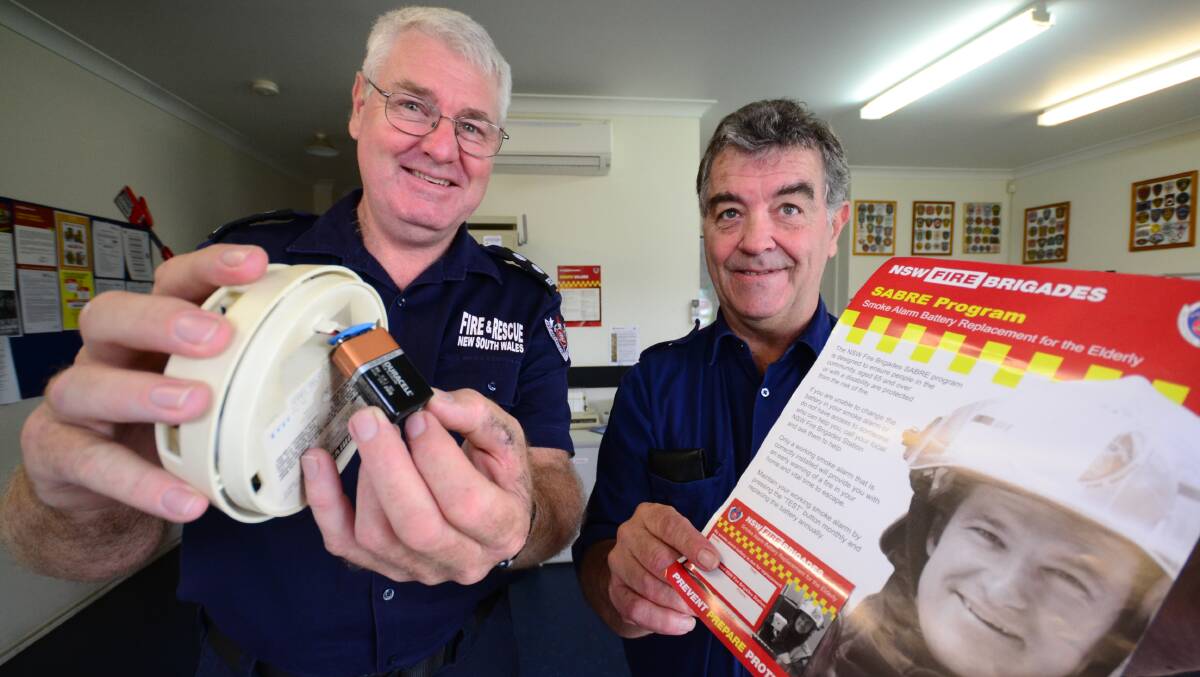 SAFETY FIRST: Nowra station officer Greg Bathurst and firefighter Jason Bridgen encourage homeowners to change their smoke alarm batteries on Sunday when they turn back the clocks for the end of daylight saving. 