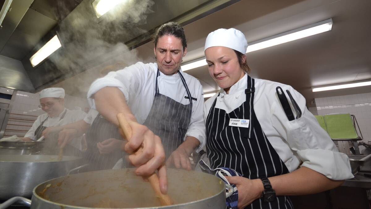 FAST AND FRESH: My Kitchen Rules judge Colin Fassnidge and second-year apprentice chef Josie Strong work hard alongside fellow students in this year’s TAFE celebrity chef dinner.