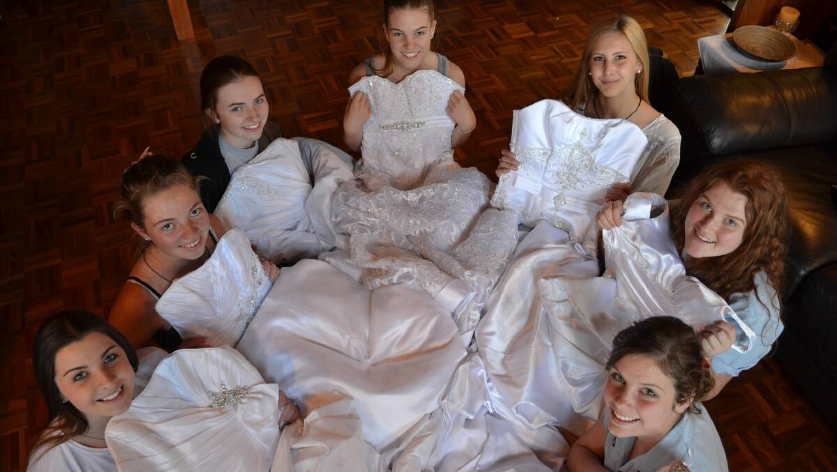 TRADITION: Shoalhaven High School students Victoria Pattie, Hannah Hedger and Kimberley Cotterill, Bomaderry High School students Ebonie Lynch and Ruby Hoye and Vincentia High School students Sarah Kenny and Lara Norton pick their donated gowns for the Shoalhaven Bravehearts Debutante Ball next month.