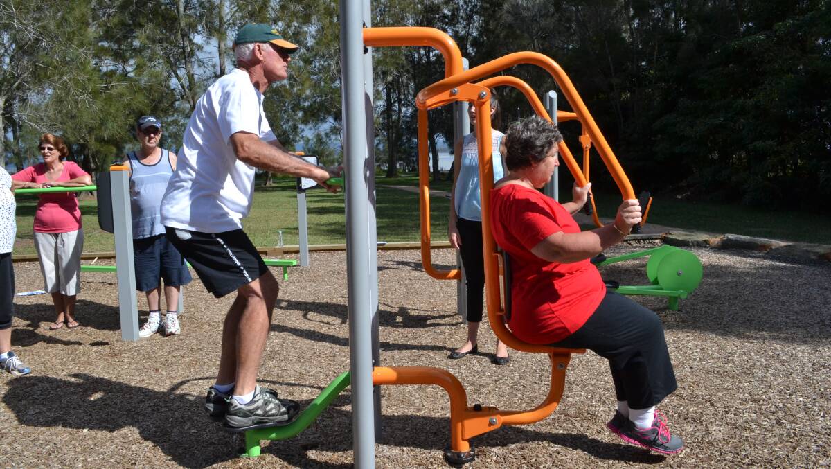 STAY ACTIVE: John Nettle and Vickie Archer from Sanctuary Point get the right advice about how to use the chest press and body twist at the outdoor gym in Sanctuary Point.